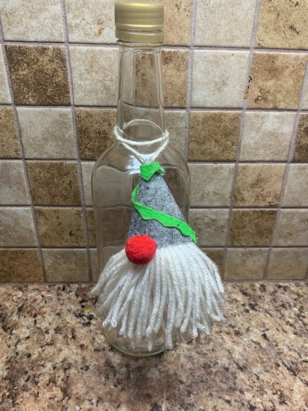 Glass bottle handcrafted gnome topper w/ gray felt hat/ white yarn beard/red nos